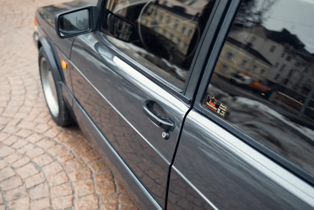 Close-up of car door and side mirror.