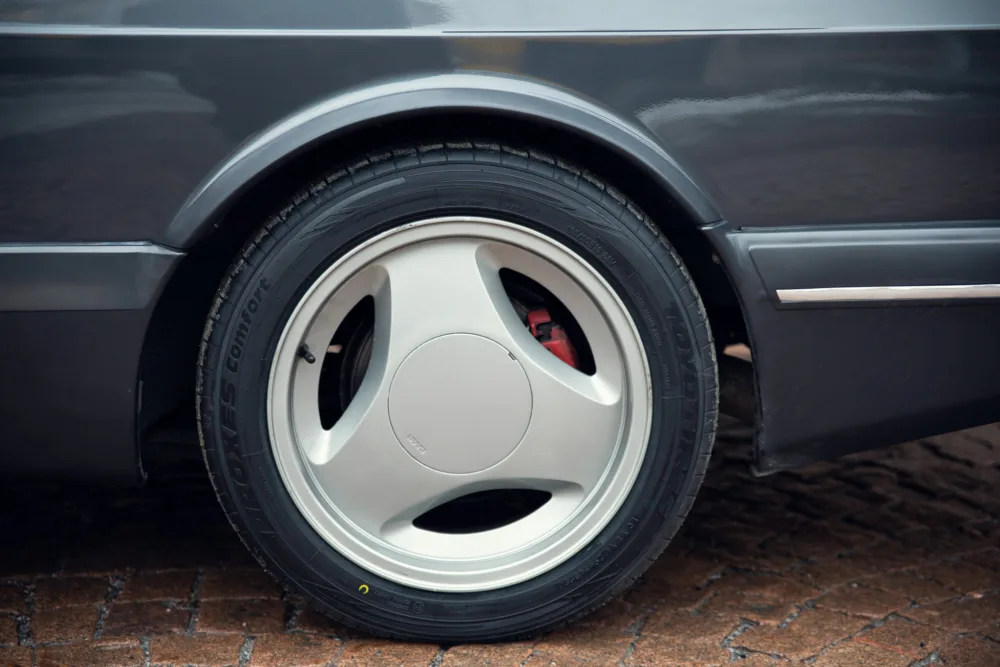 Car wheel close-up on brick pavement