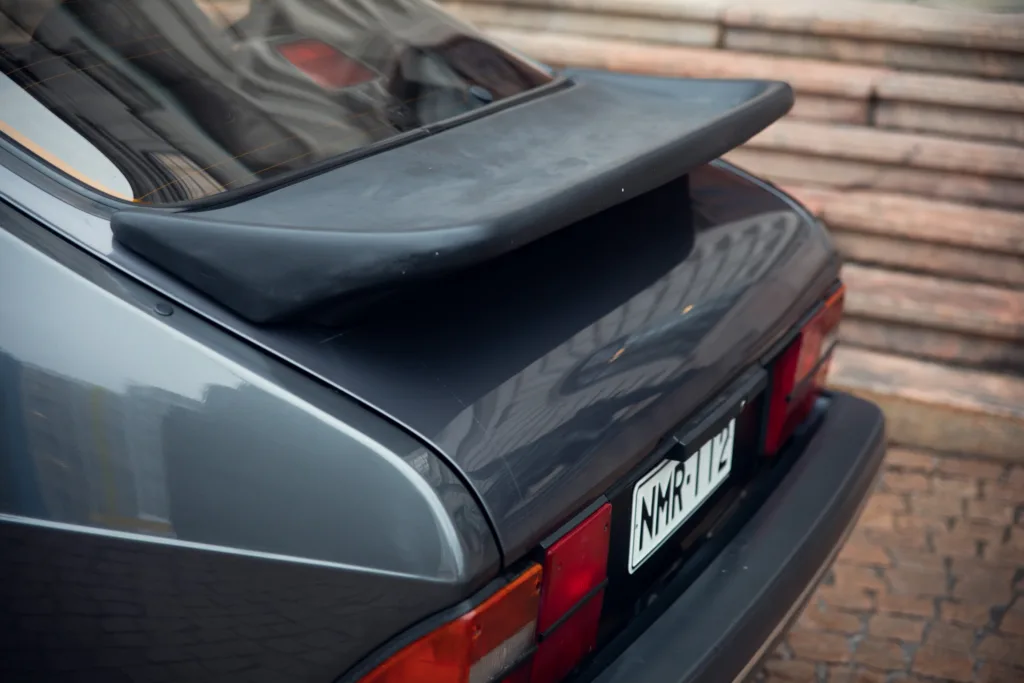 Vintage car with rear spoiler and distinctive tail lights.