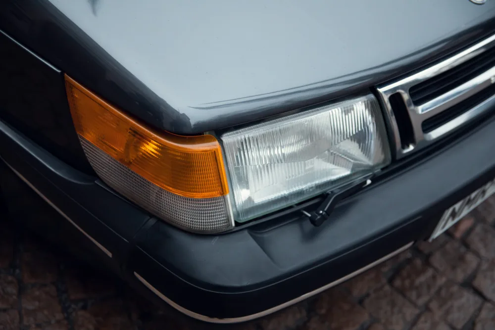 Close-up of a car's headlight and grille.