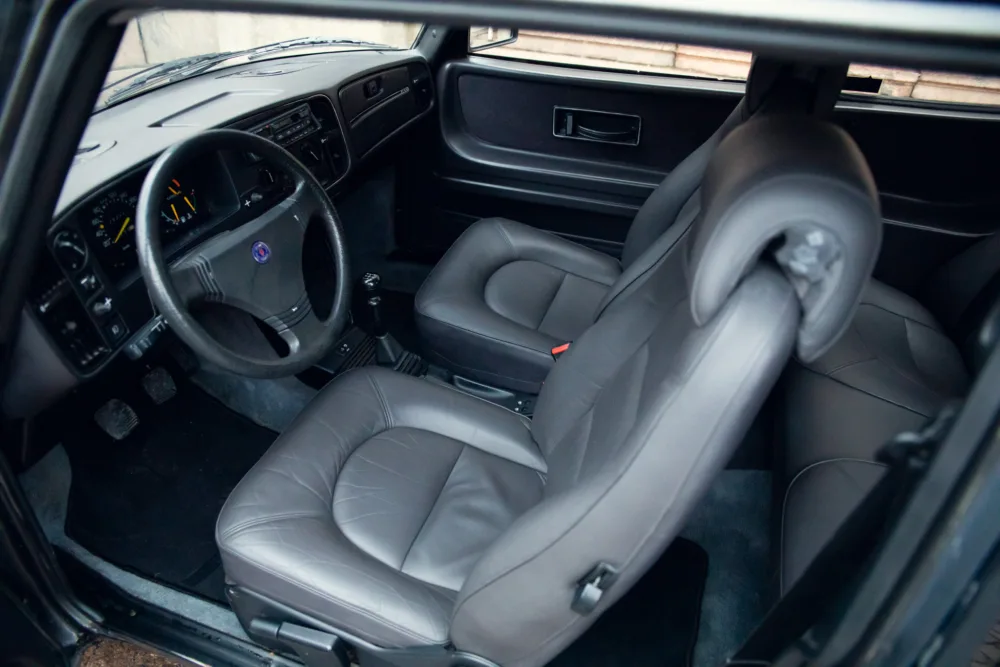 Car interior with leather seats and dashboard.