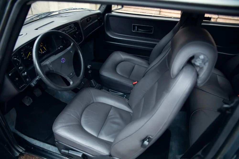 Interior of a vehicle with leather seats and steering wheel