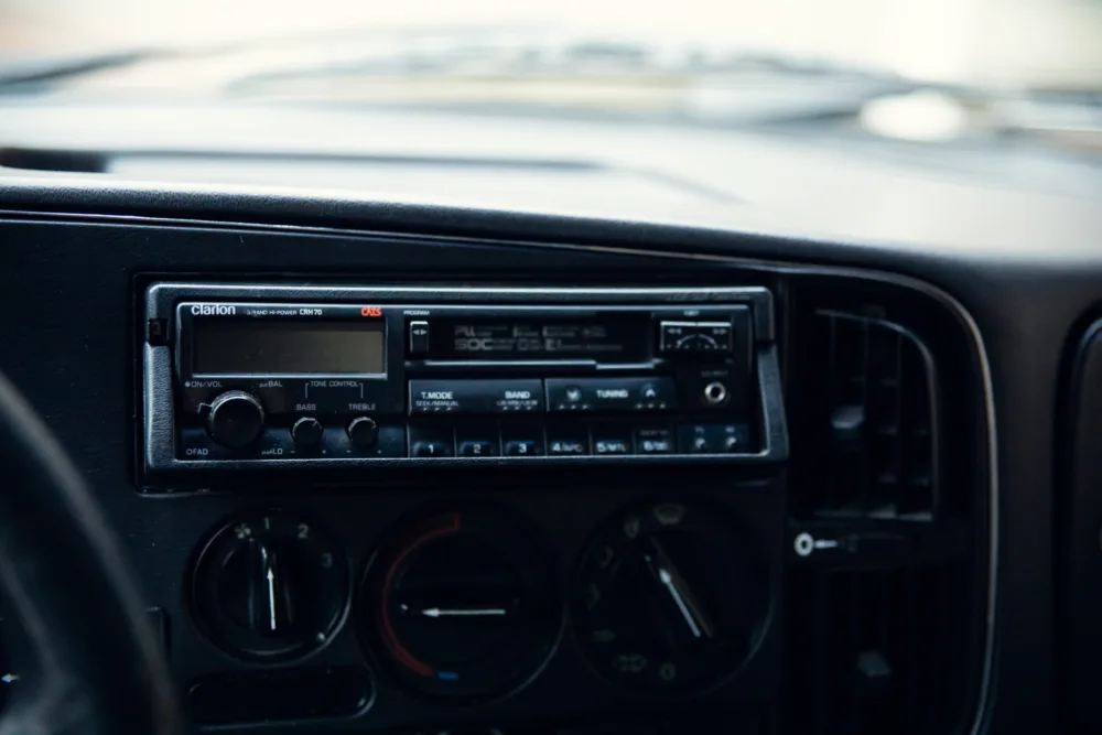 Vintage Clarion car stereo and dashboard.