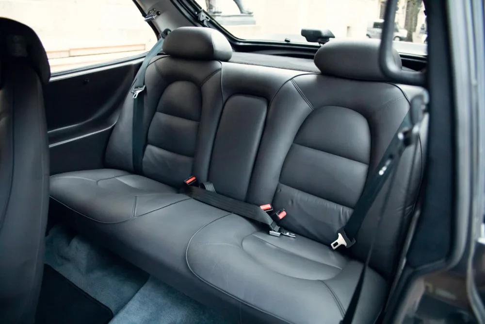 Black leather car rear seat interior.