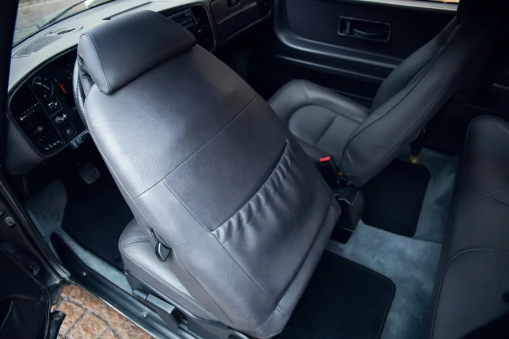 Car interior with leather seats and dashboard view.