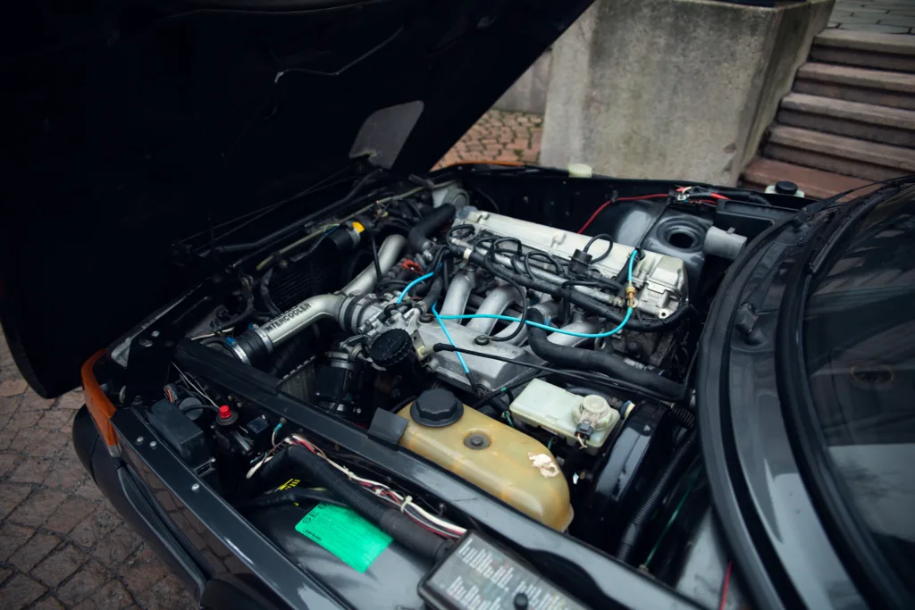 Car engine bay with open hood.