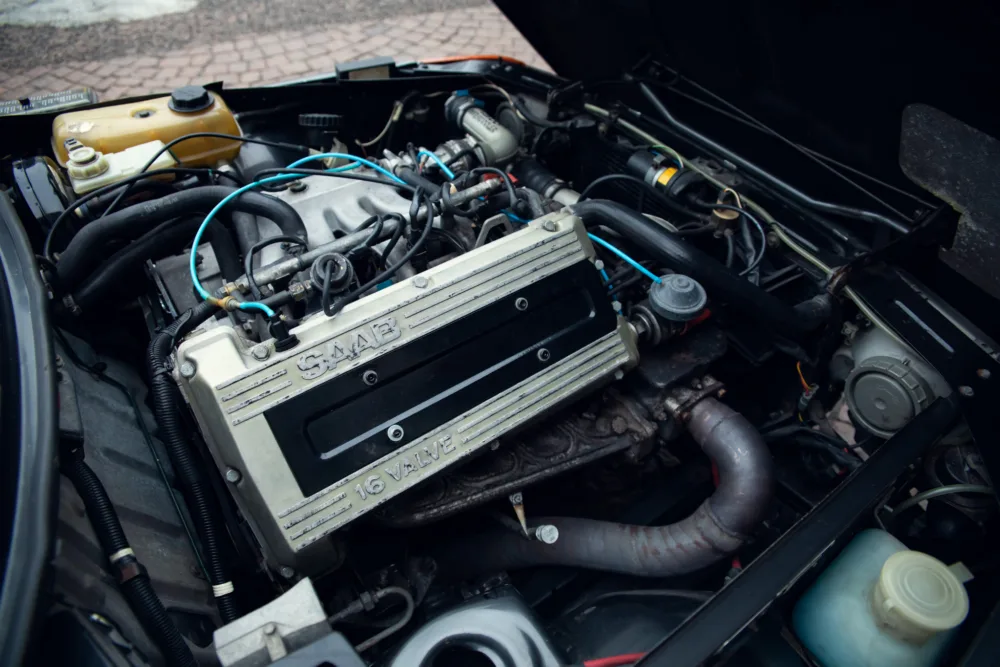 Car engine bay with Saab 16-valve turbo engine.