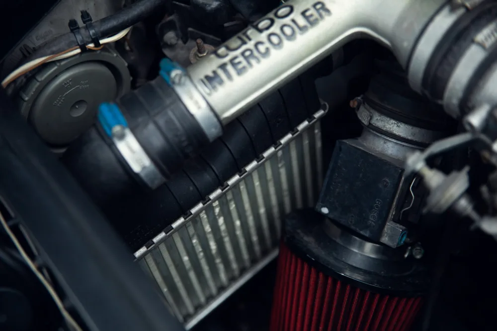 Car engine with turbo intercooler and air filter.