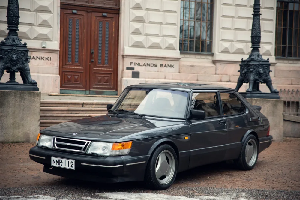 Vintage Saab car in front of Finland's Bank building.