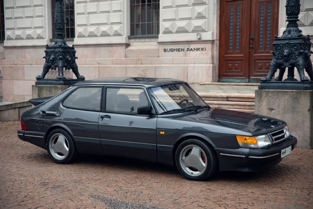 Vintage Saab car parked near historical building