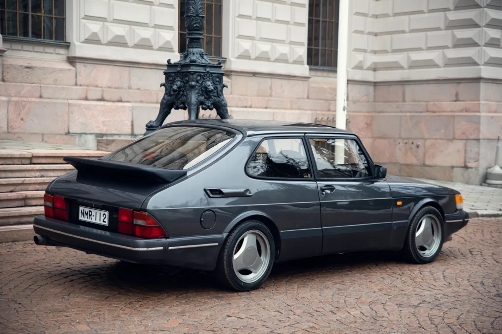 Classic car parked near historic building.