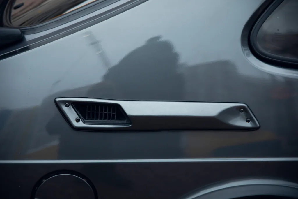 Car side air vent close-up.