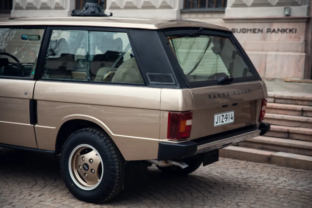 Classic beige Range Rover parked outdoors.
