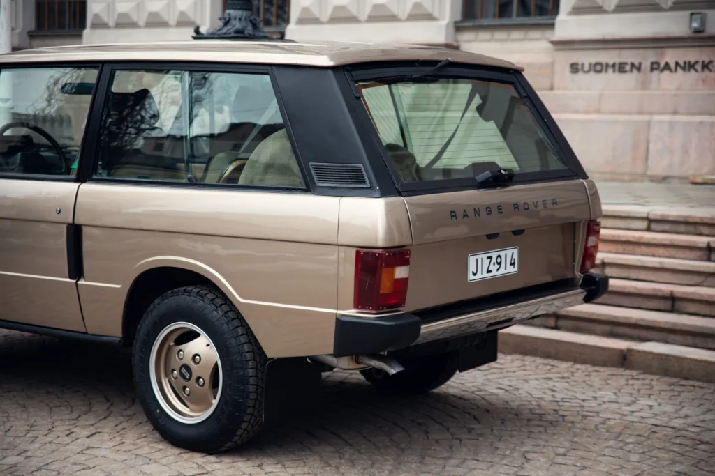 Vintage Range Rover parked in urban setting.