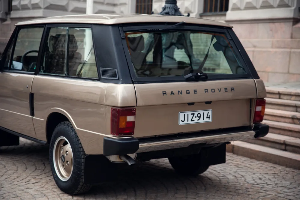 Vintage Range Rover parked on cobblestone street