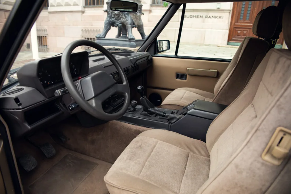 Vintage car interior with steering wheel and seats