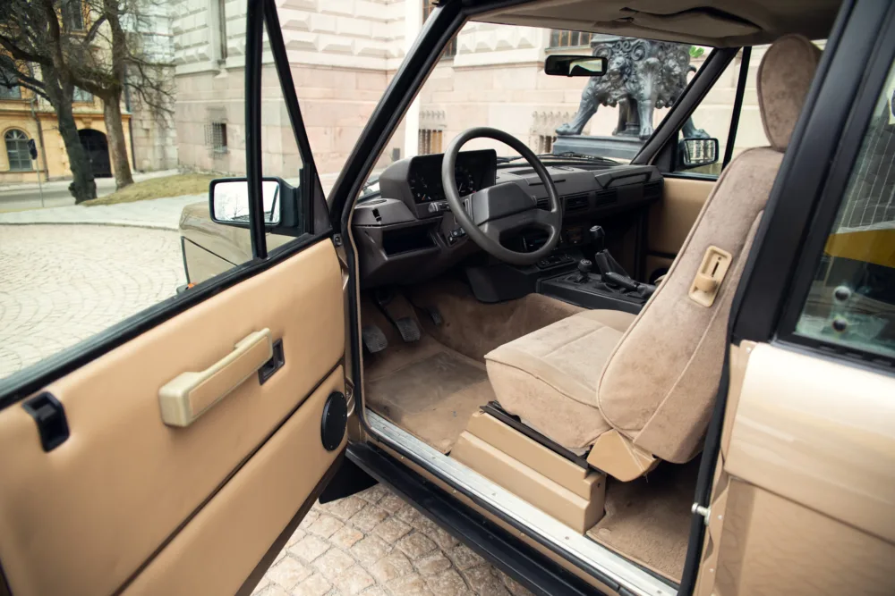 Vintage car interior with open door.