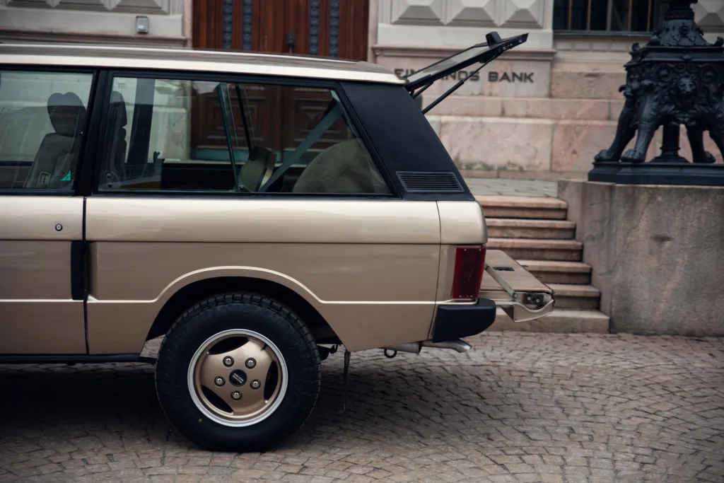 Vintage car parked near historic building.