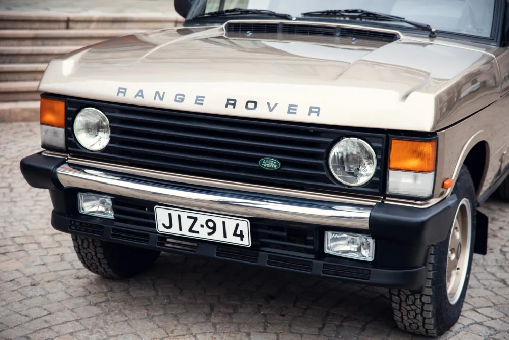 Vintage Range Rover front view on cobblestone.