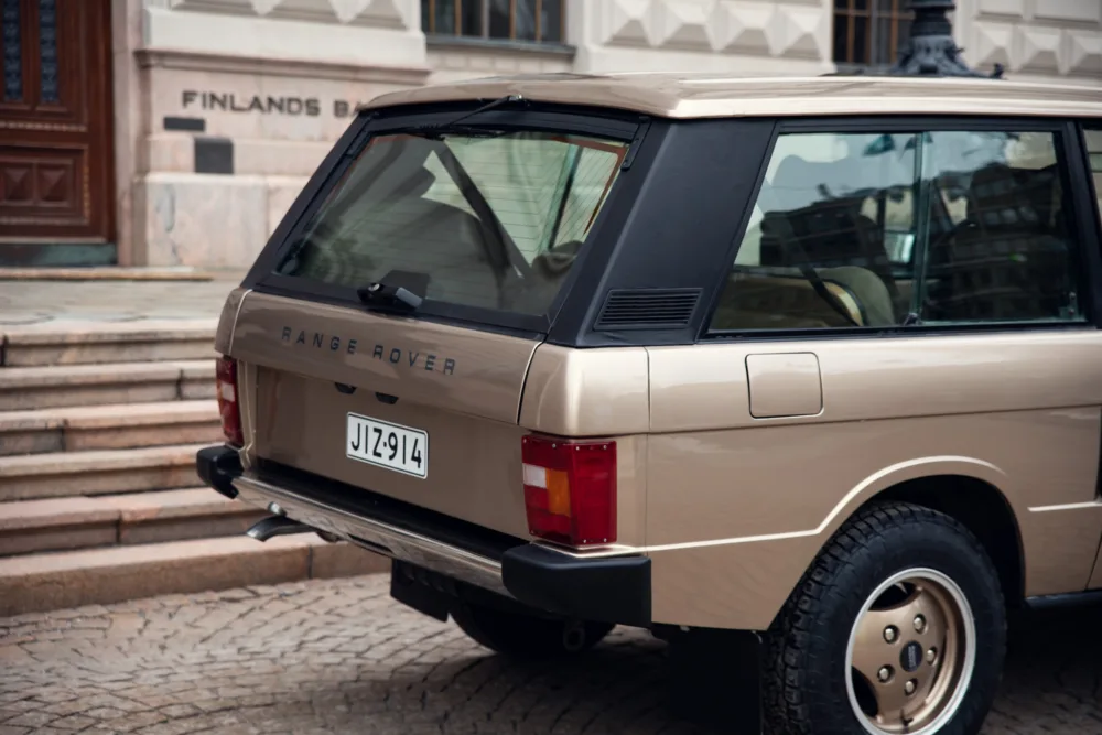Vintage beige Range Rover parked outdoors.