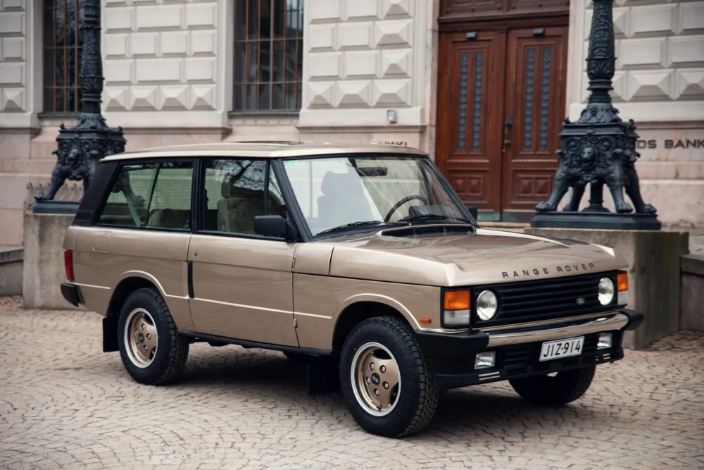 Vintage Range Rover parked on cobblestone street