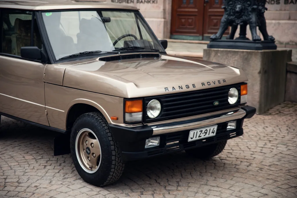 Vintage Range Rover parked on cobblestone street