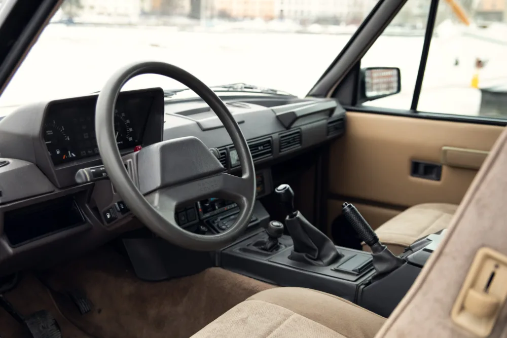 Vintage car interior with manual transmission.
