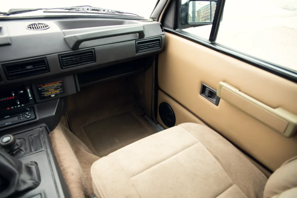 Vintage car interior with tan upholstery.
