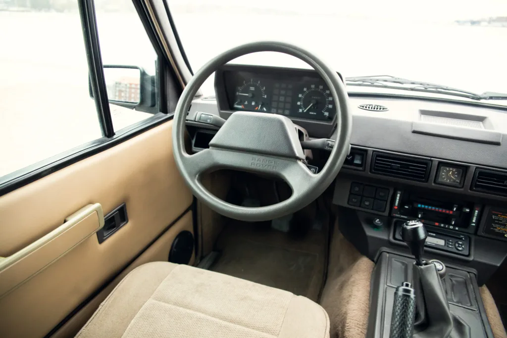 Vintage vehicle interior with steering wheel and dashboard