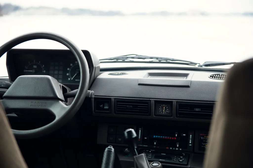 Interior view of Range Rover dashboard and steering wheel.