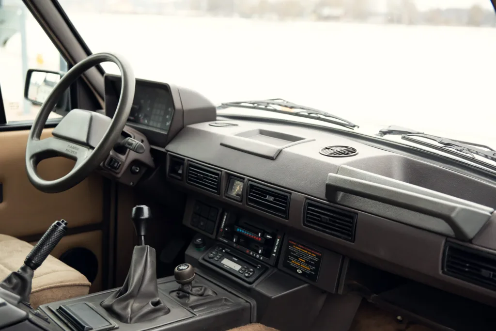 Vintage car dashboard and steering wheel.
