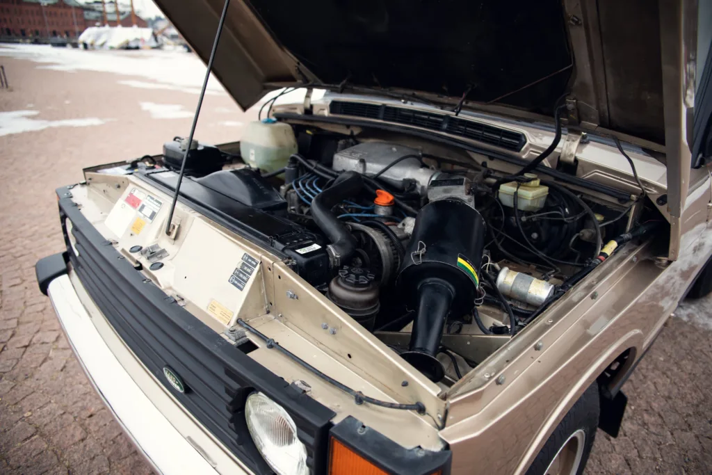 Vintage car engine bay open.