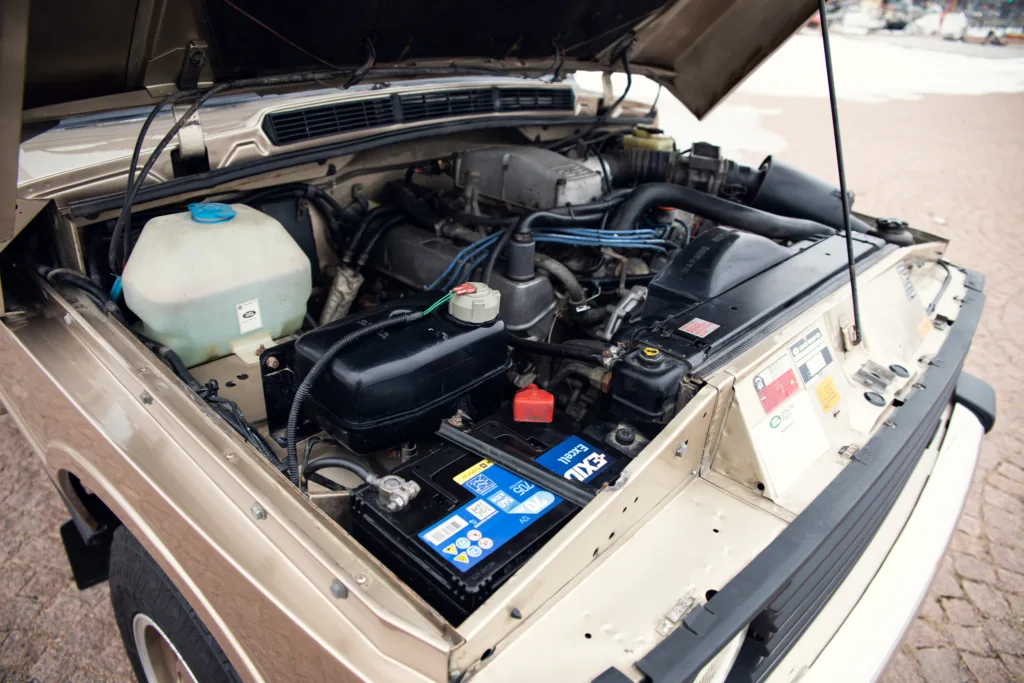 Car engine bay with open hood.