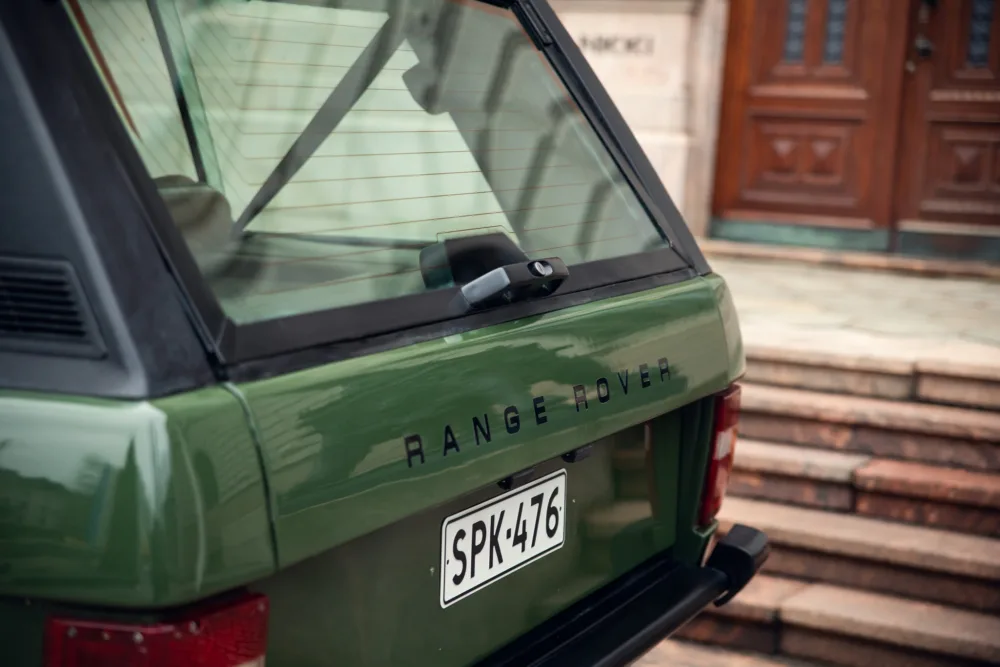 Green Range Rover rear view with license plate