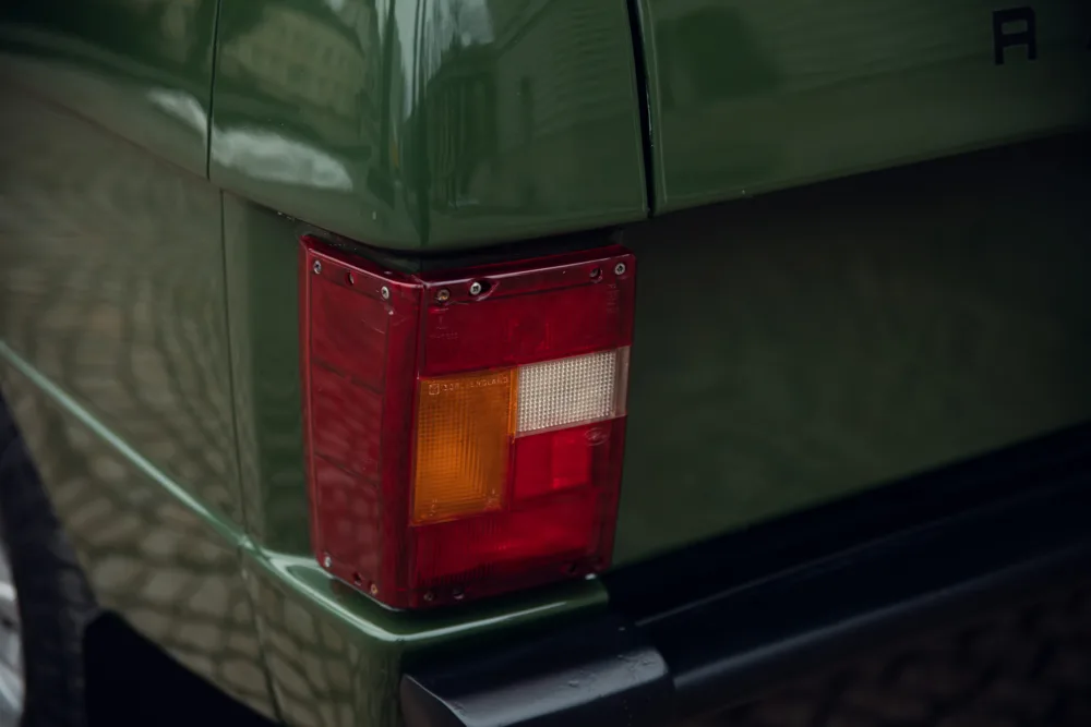 Vintage car's red tail light detail.