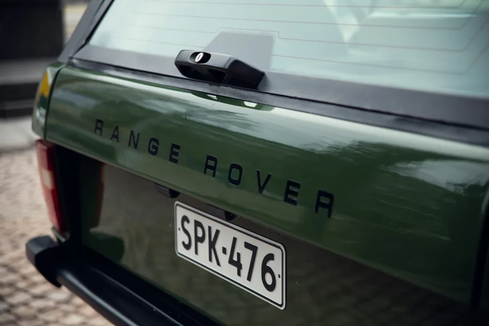 Green Range Rover tailgate and license plate detail.