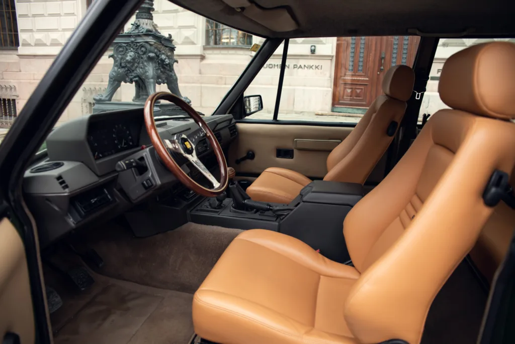 Vintage car interior with tan leather seats.