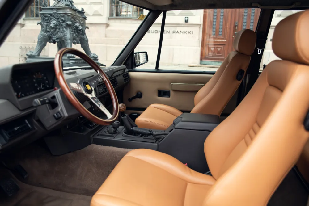 Vintage car interior with tan leather seats.