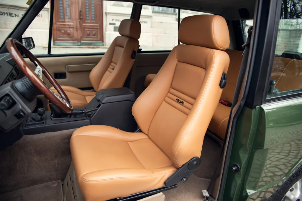 Vintage car interior with tan leather seats.