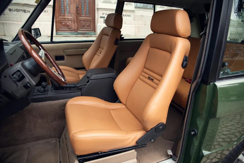 Vintage car interior with tan leather seats.