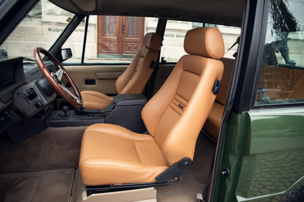 Tan leather car seats interior vintage vehicle.