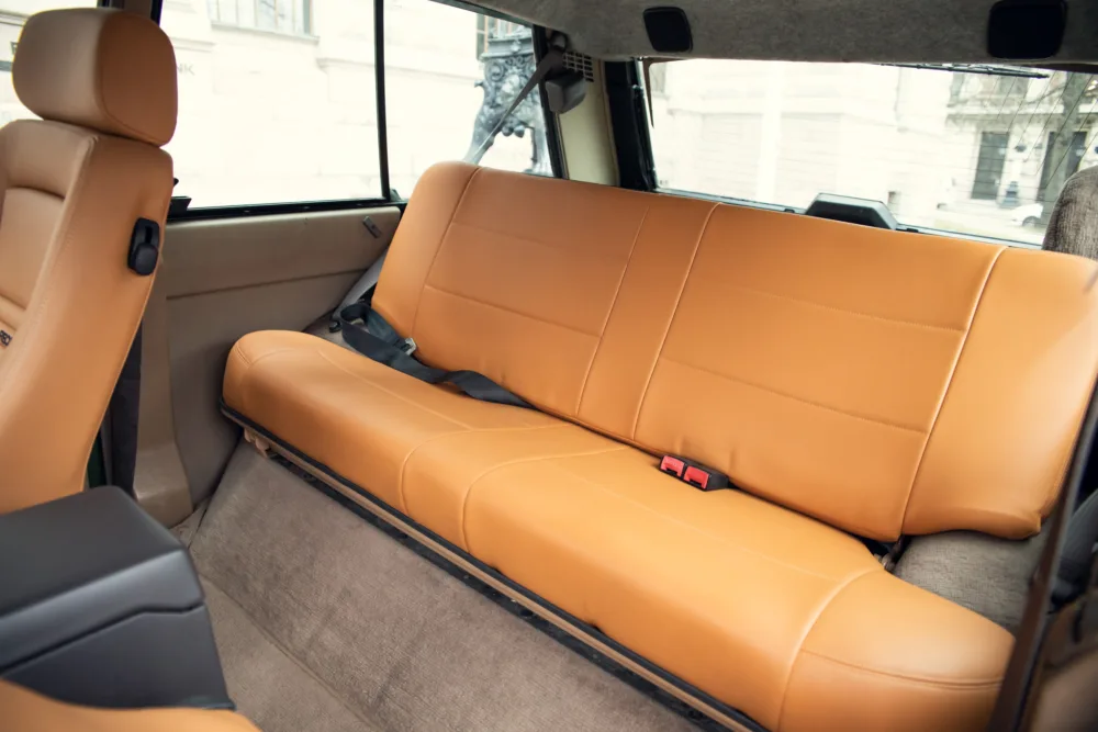 Luxury tan leather car back seat interior.