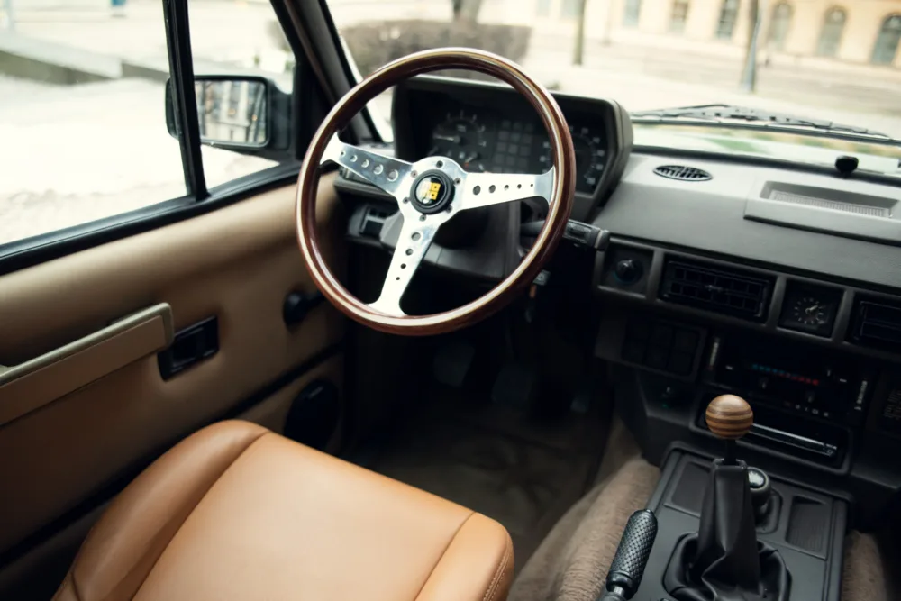 Vintage car interior with wooden steering wheel