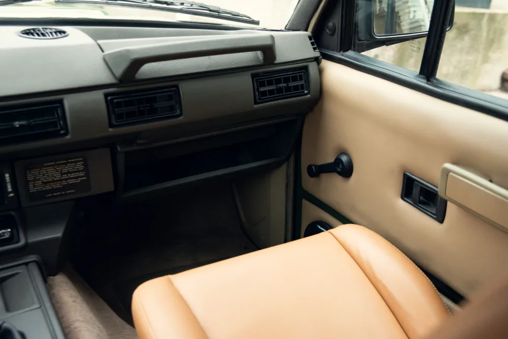 Vintage car interior dashboard and passenger seat.