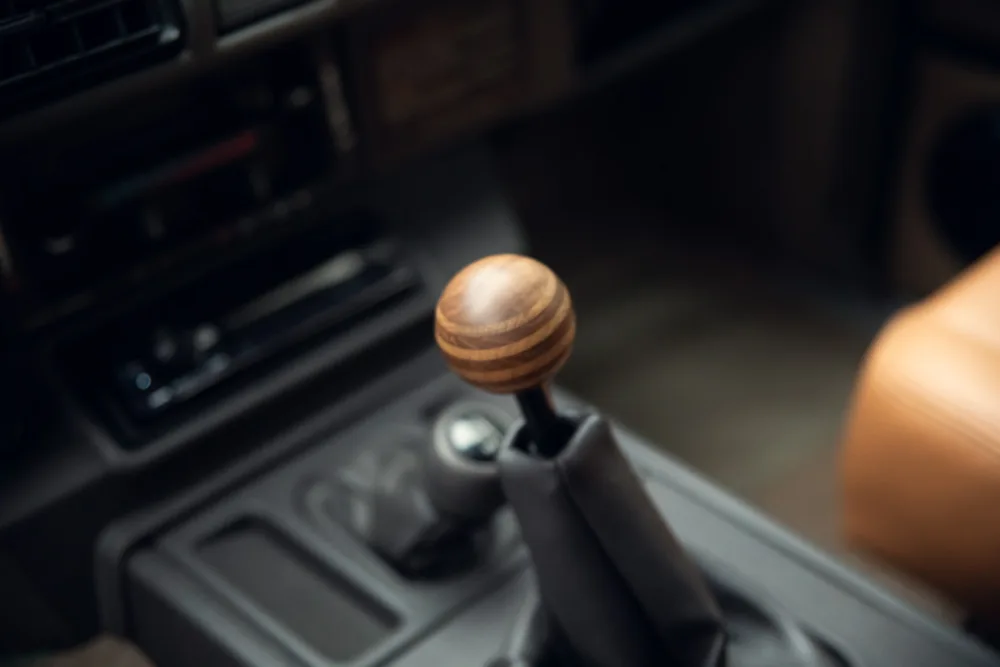 Wooden gear shift knob in vehicle interior