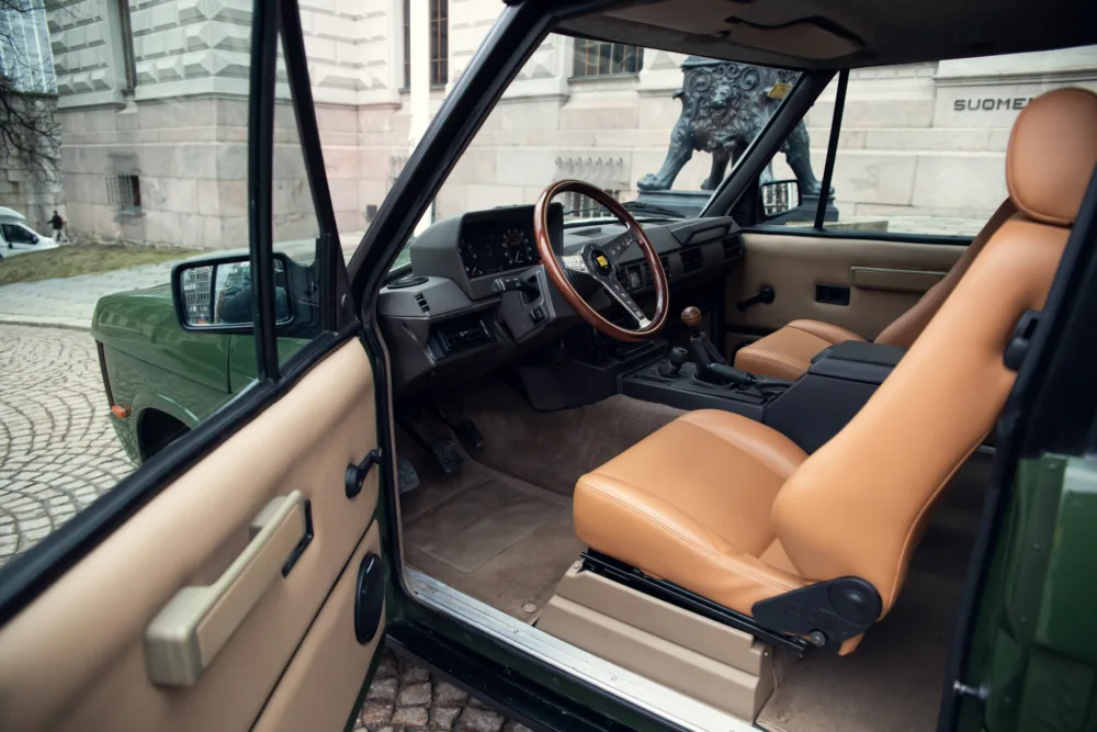 Vintage car interior with tan leather seats.