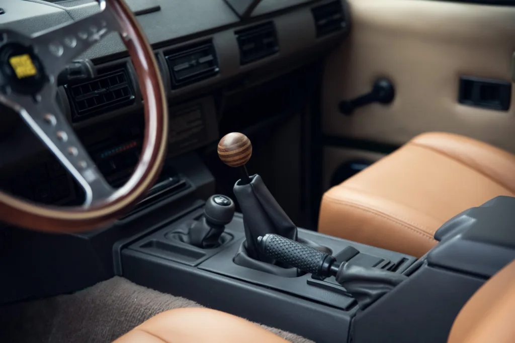 Vintage car interior with wooden gear shift knob.