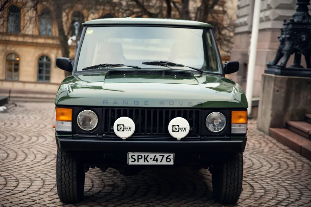Classic green Range Rover parked outdoors.