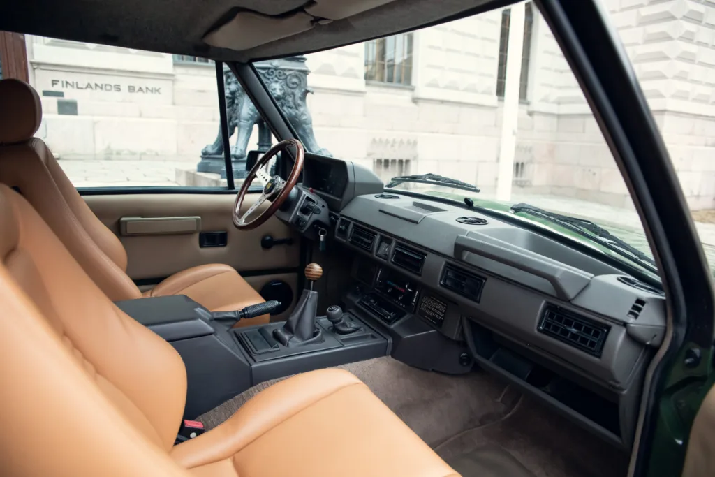 Vintage car interior with leather seats and dashboard.