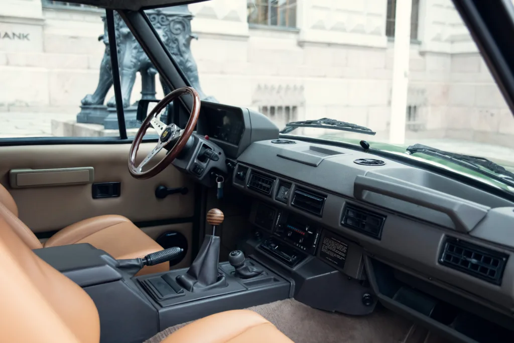 Vintage car interior with tan leather seats.